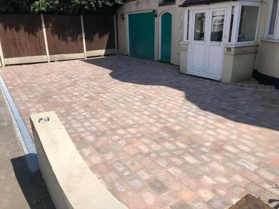 The same front laid in pink and brindle tumbled block paving with a drainage channel by the wall
